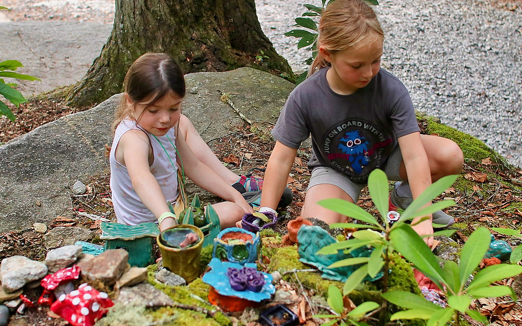 two kids playing together outside