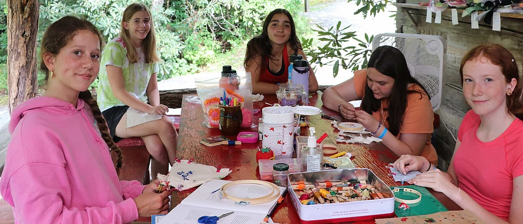 community of girls sewing