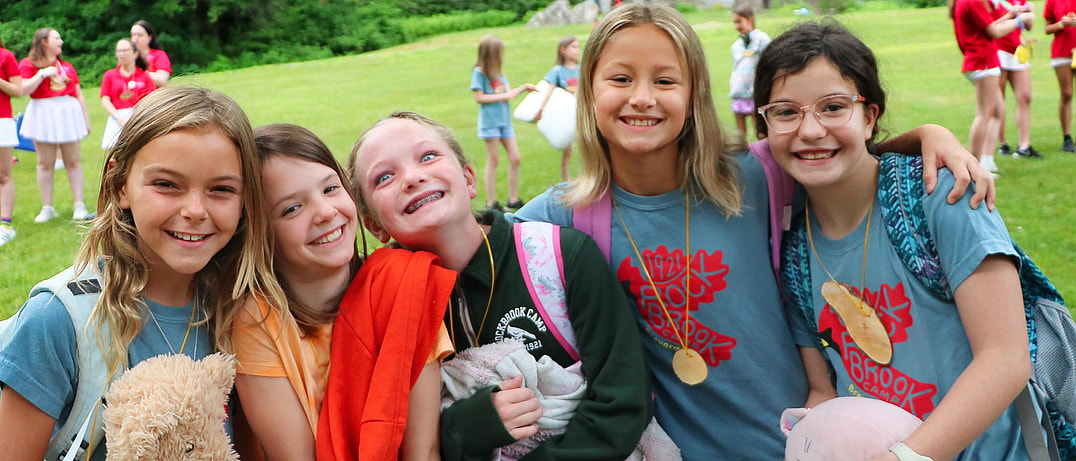 summer camp kids arriving with stuffed animals