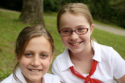 child with glasses at camp