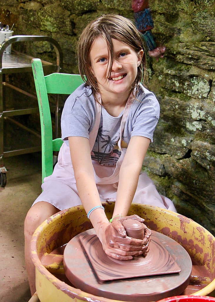 young potter learning the wheel