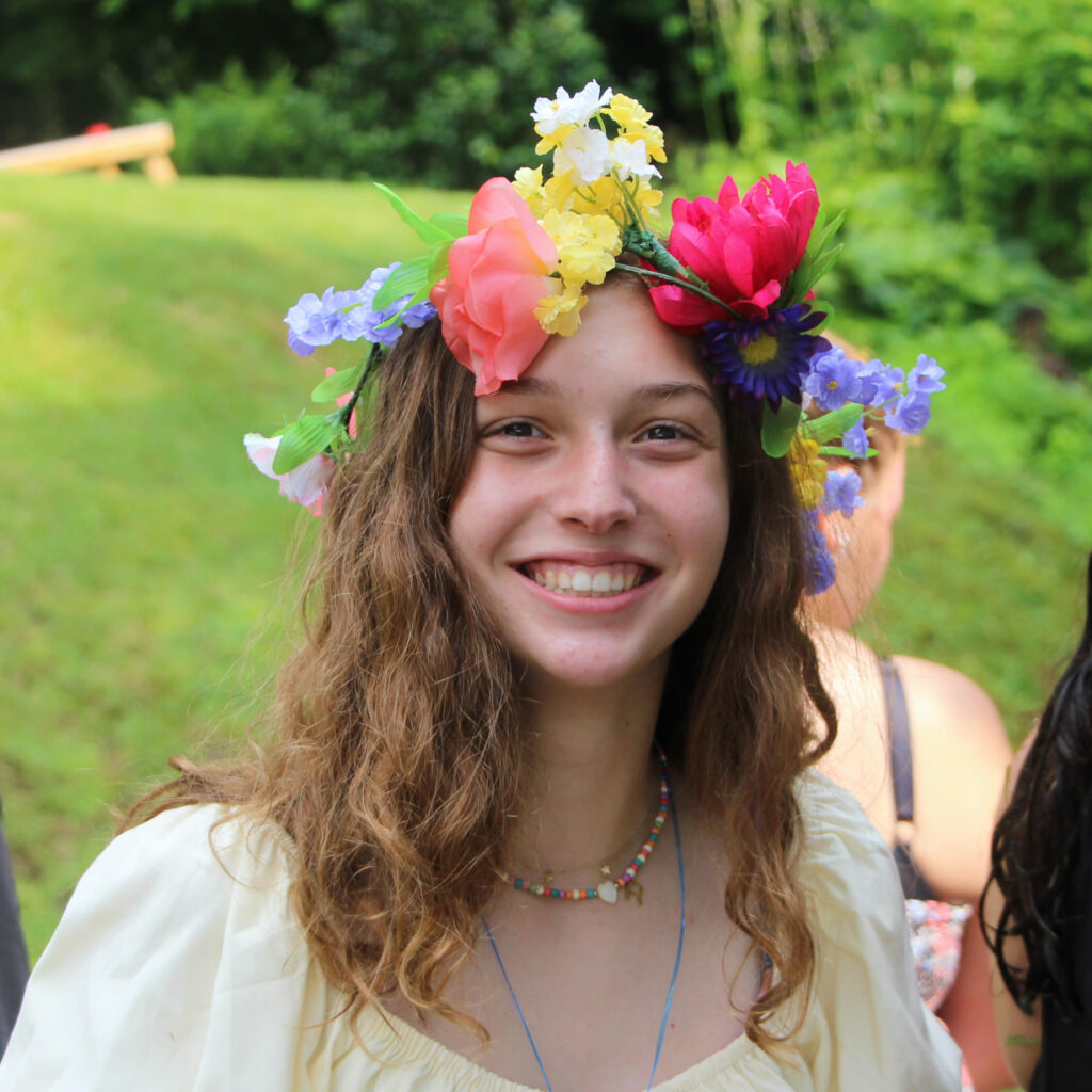 teenager wearing flower crown at camp