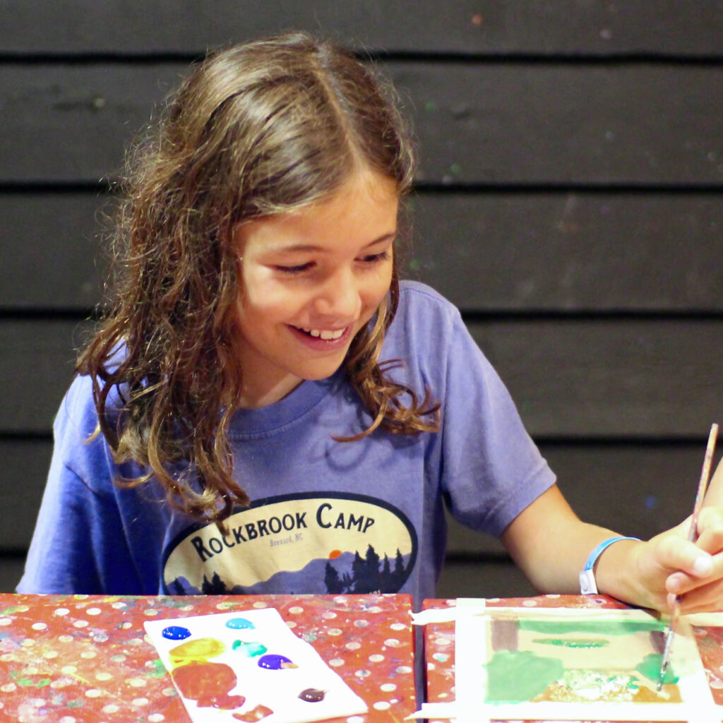 learning to paint at summer camp